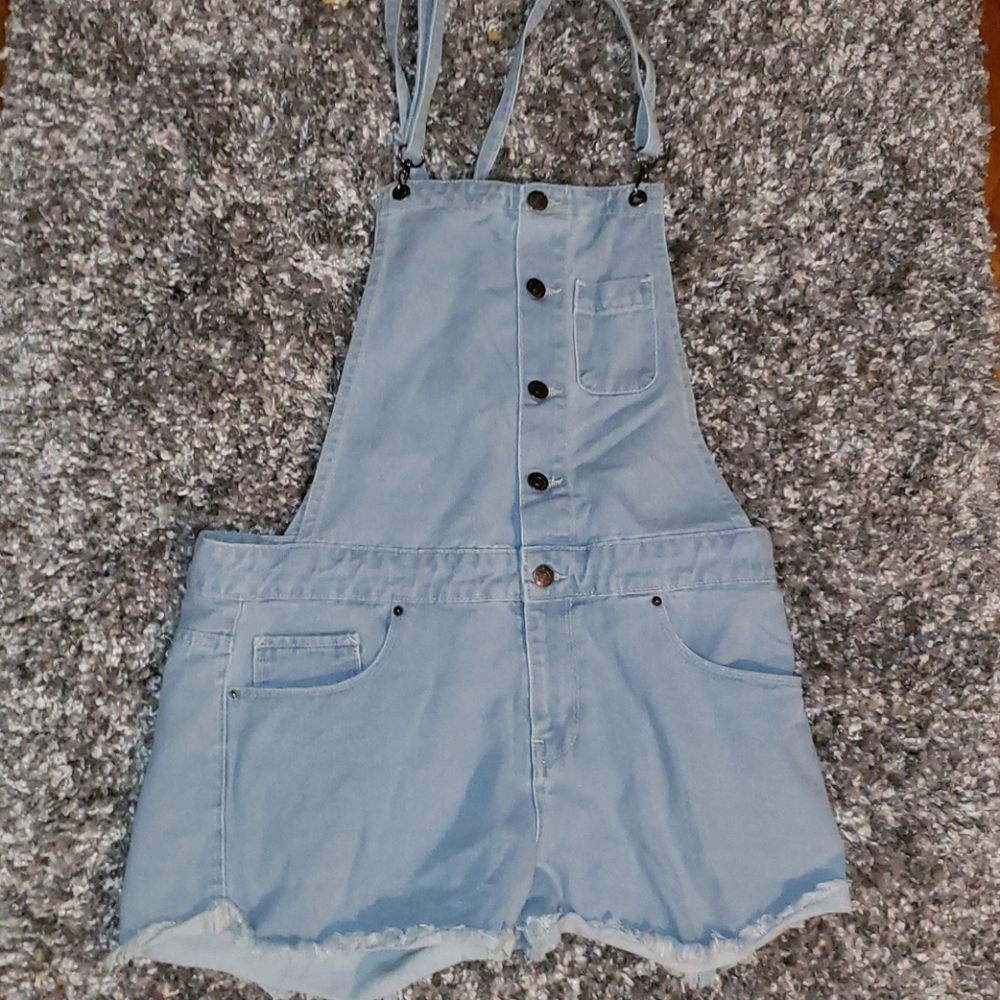 Light washed jean overalls.